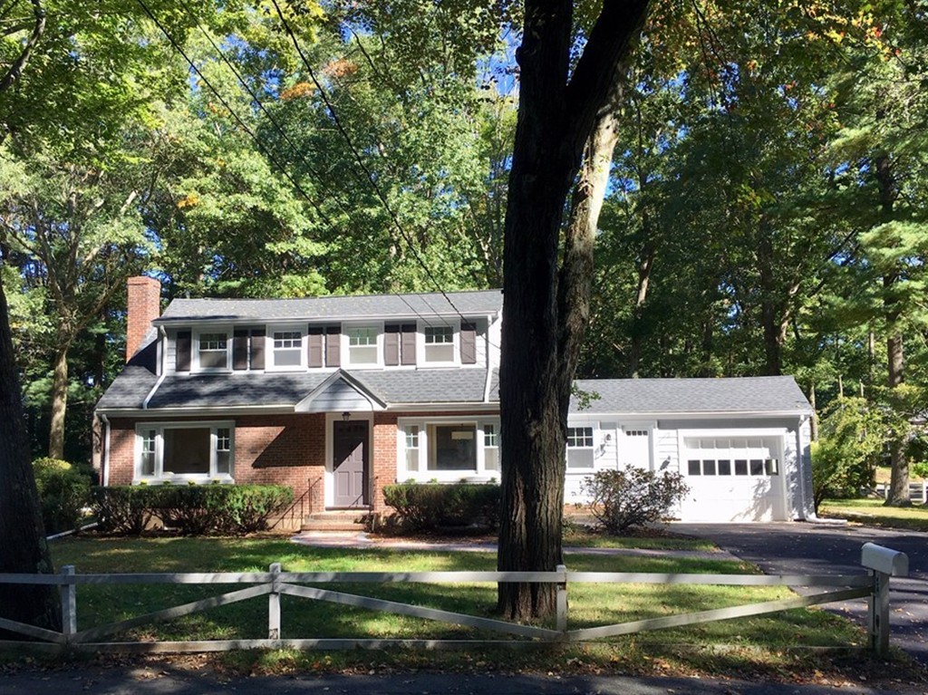 71 Stonebridge Road Wayland, MA 01778 - Photo 1 of 23 a front view of a house with a garden and trees