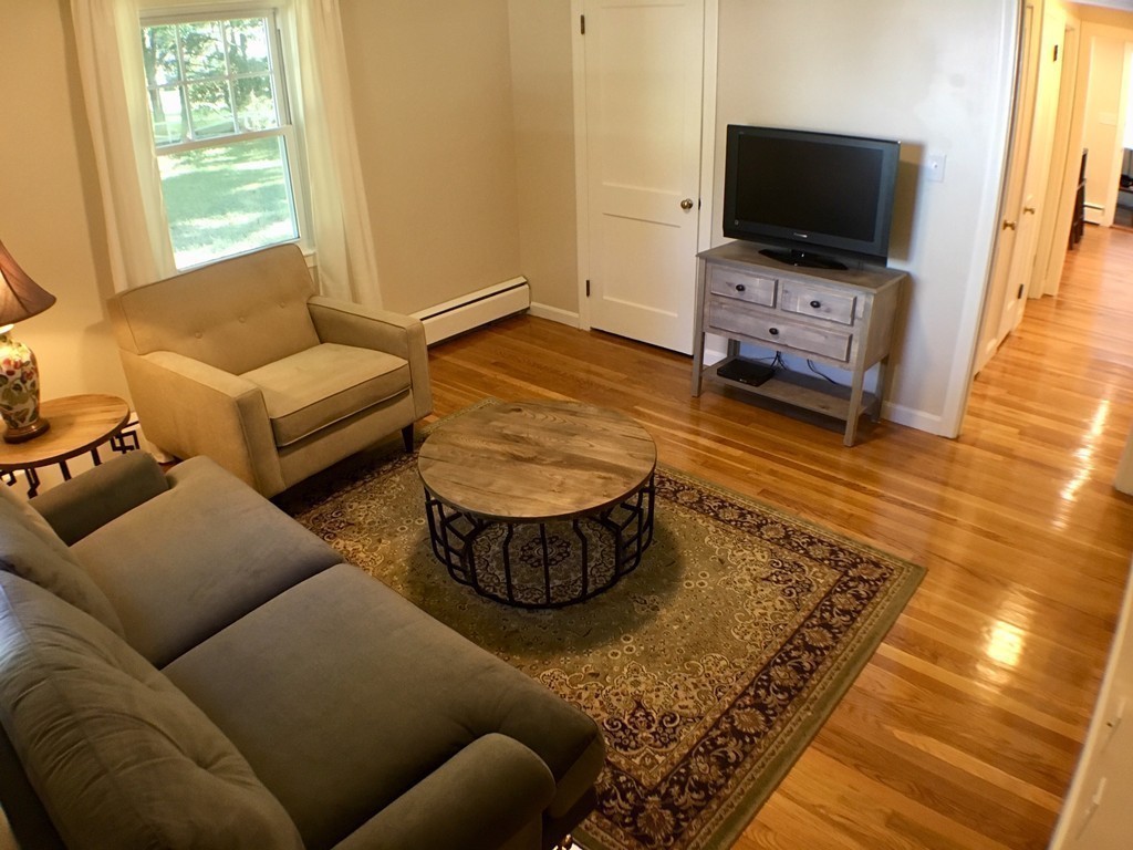 71 Stonebridge Road Wayland, MA 01778 - Photo 11 of 23 a living room with furniture and a flat screen tv