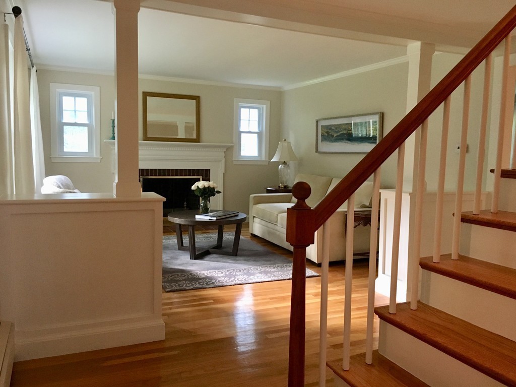71 Stonebridge Road Wayland, MA 01778 - Photo 3 of 23 a living room with furniture a fireplace and wooden floor
