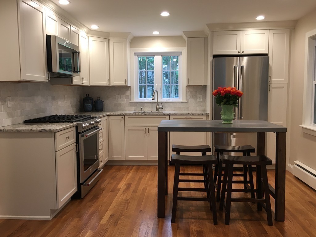 71 Stonebridge Road Wayland, MA 01778 - Photo 8 of 23 a kitchen with stainless steel appliances granite countertop a white cabinets and a refrigerator