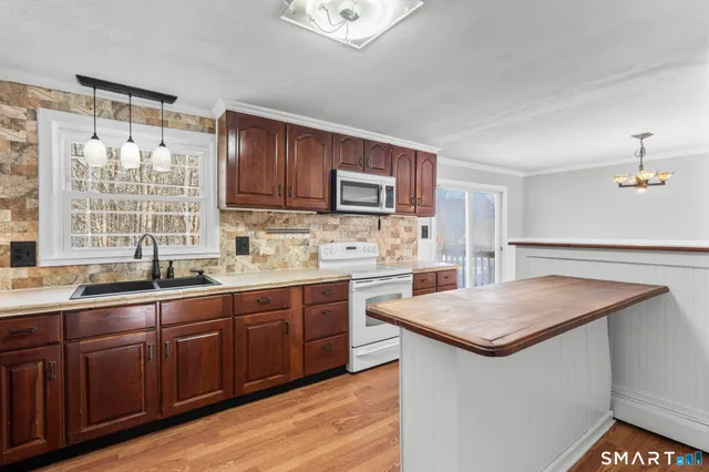a kitchen with stainless steel appliances granite countertop a sink and stove