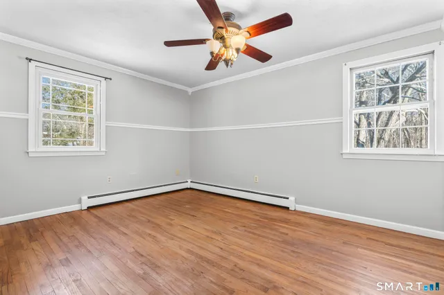 wooden floor in an empty room with a window