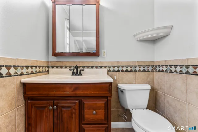 a view of walk in closet with window and wooden floor