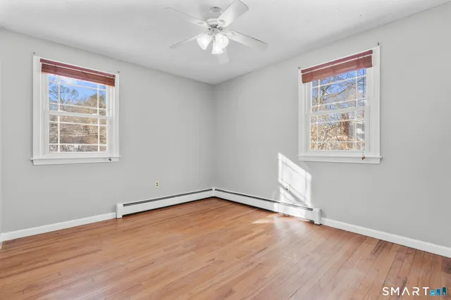 wooden floor in an empty room with a window