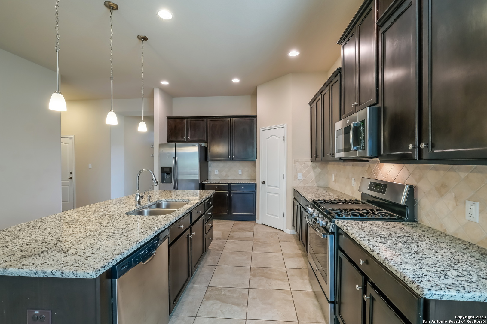 a kitchen with granite countertop stainless steel appliances lots of counter top space