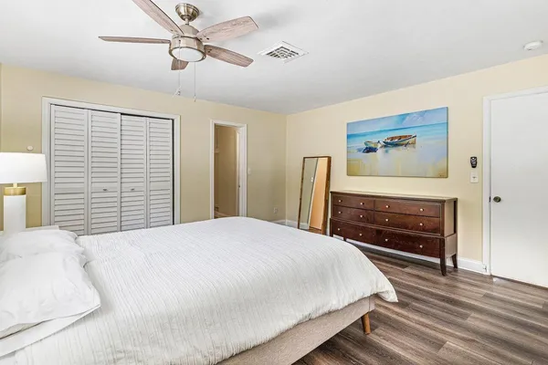 a bedroom with a bed and a dresser