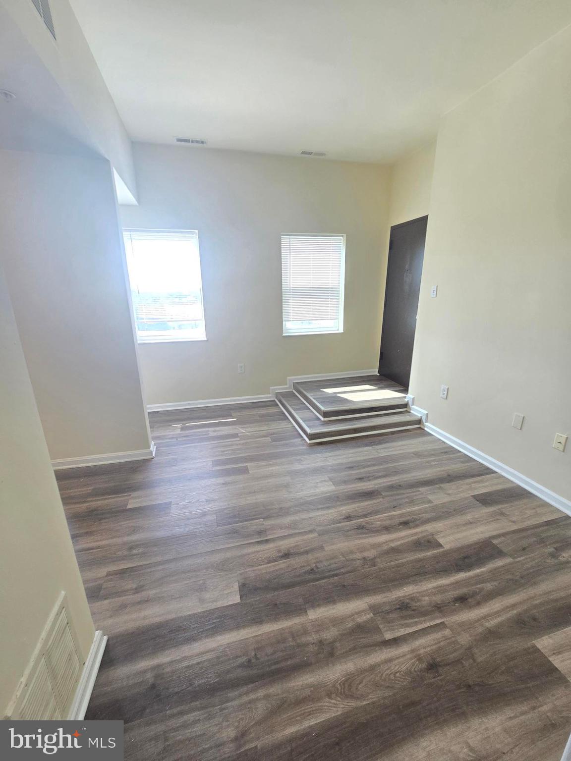 317 North Avenue East, Unit 112 Baltimore, MD 21202 - Photo 5 of 11 a view of wooden floor and windows in a room