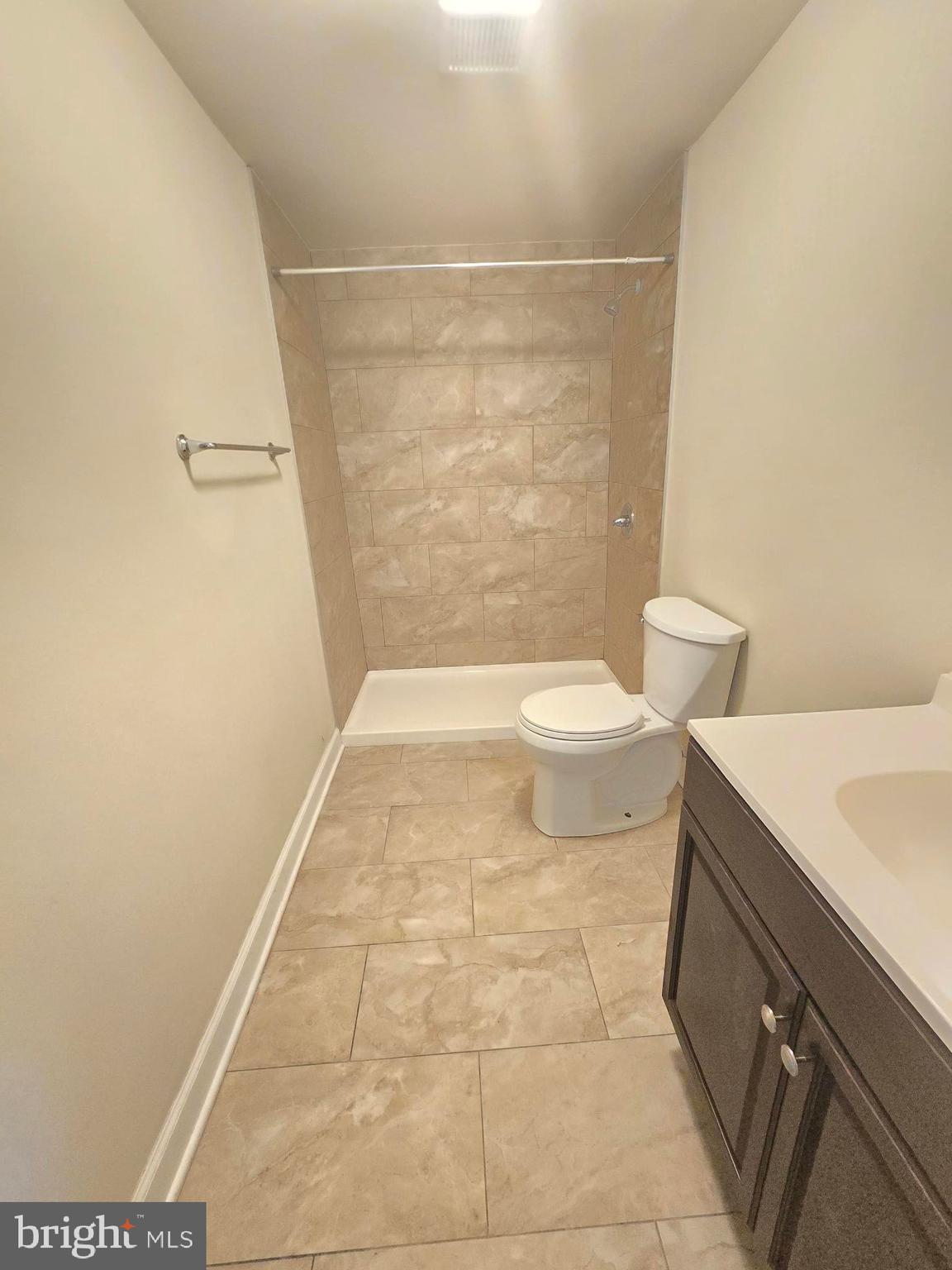 317 North Avenue East, Unit 112 Baltimore, MD 21202 - Photo 7 of 11 a bathroom with a shower and a toilet