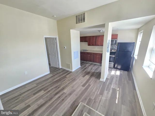 a view of kitchen and wooden floor