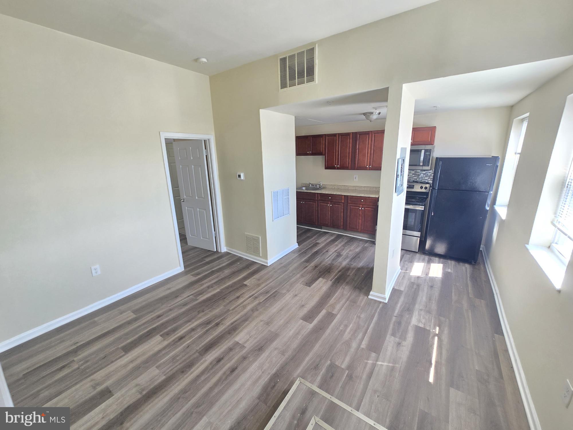 317 North Avenue East, Unit 112 Baltimore, MD 21202 - Photo 9 of 11 a view of kitchen and wooden floor