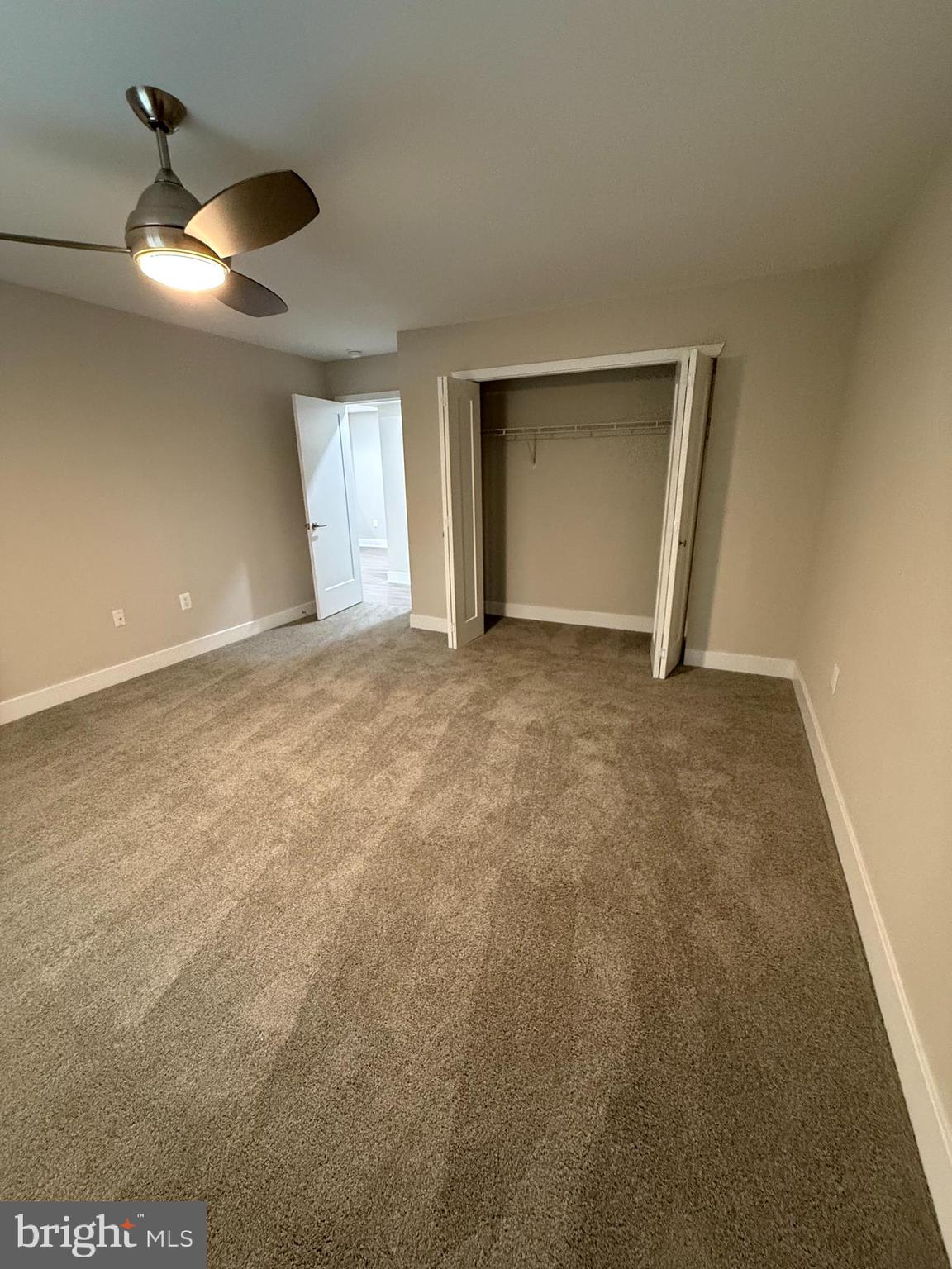 1003 Easton Road, Unit C502 Willow Grove, PA 19090 - Photo 5 of 6 a view of an empty room with a ceiling fan and window