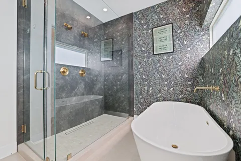 a white bath tub sitting in a bathroom