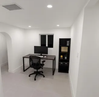 a view of a house with swimming pool and sitting area