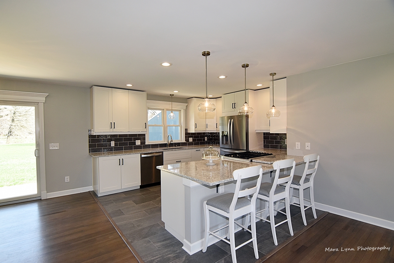 2S643 Nelson Lake Road Batavia, IL 60510 - Photo 8 of 48 a room with kitchen island a dining table chairs and a sink