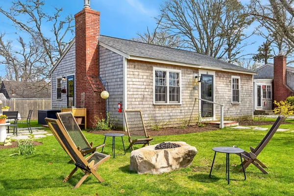 a view of a house with backyard porch and sitting area