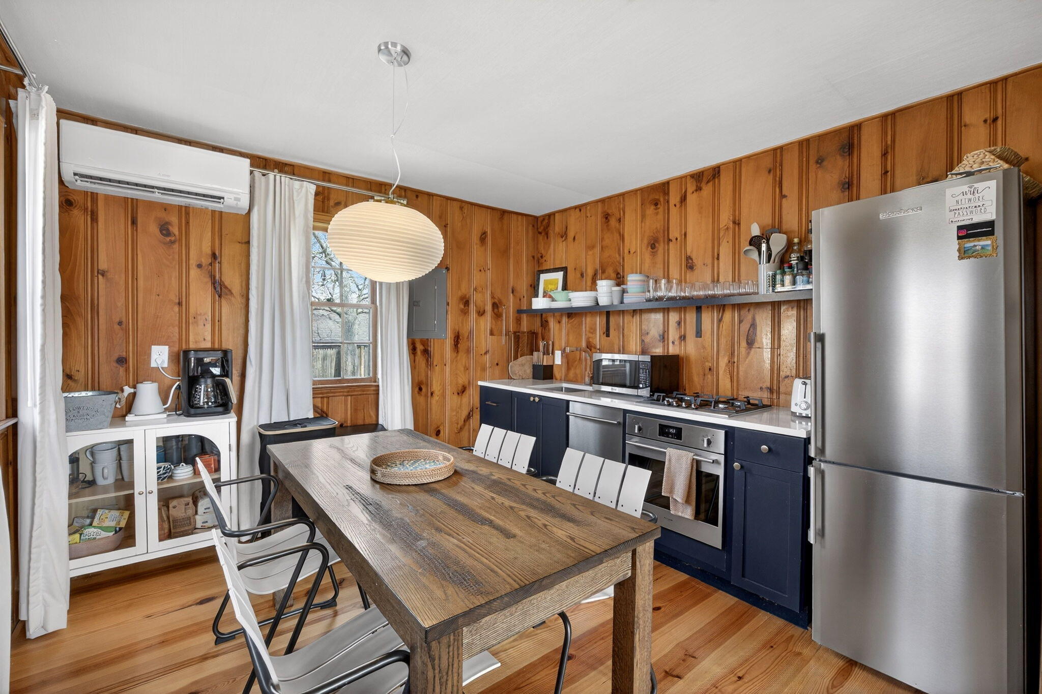 6 Manning Road Dennis Port, MA 02639 - Photo 14 of 53 a kitchen with stainless steel appliances granite countertop a refrigerator a stove a sink a dining table and chairs with wooden floor