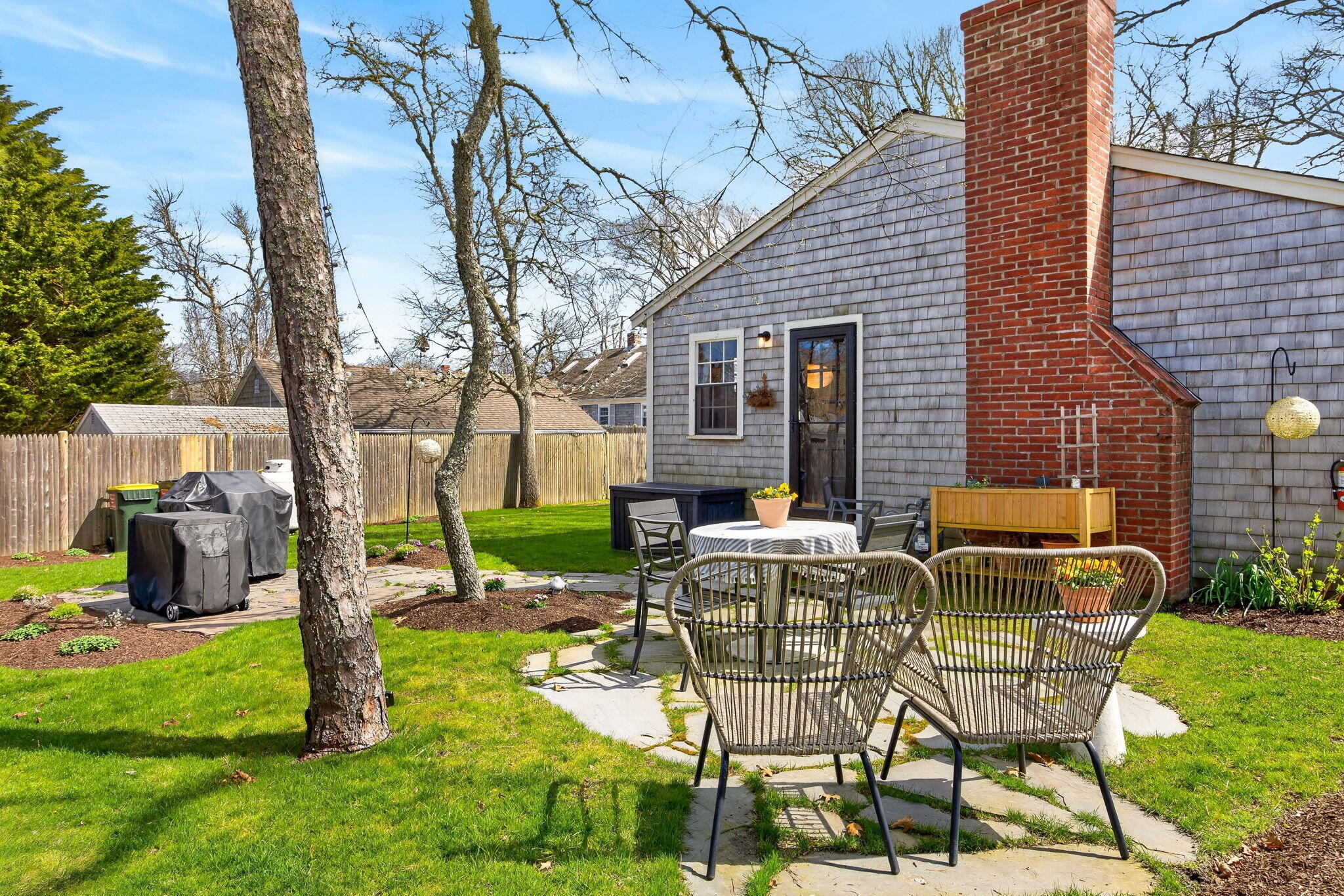 6 Manning Road Dennis Port, MA 02639 - Photo 38 of 53 a view of a chairs and table in backyard of the house