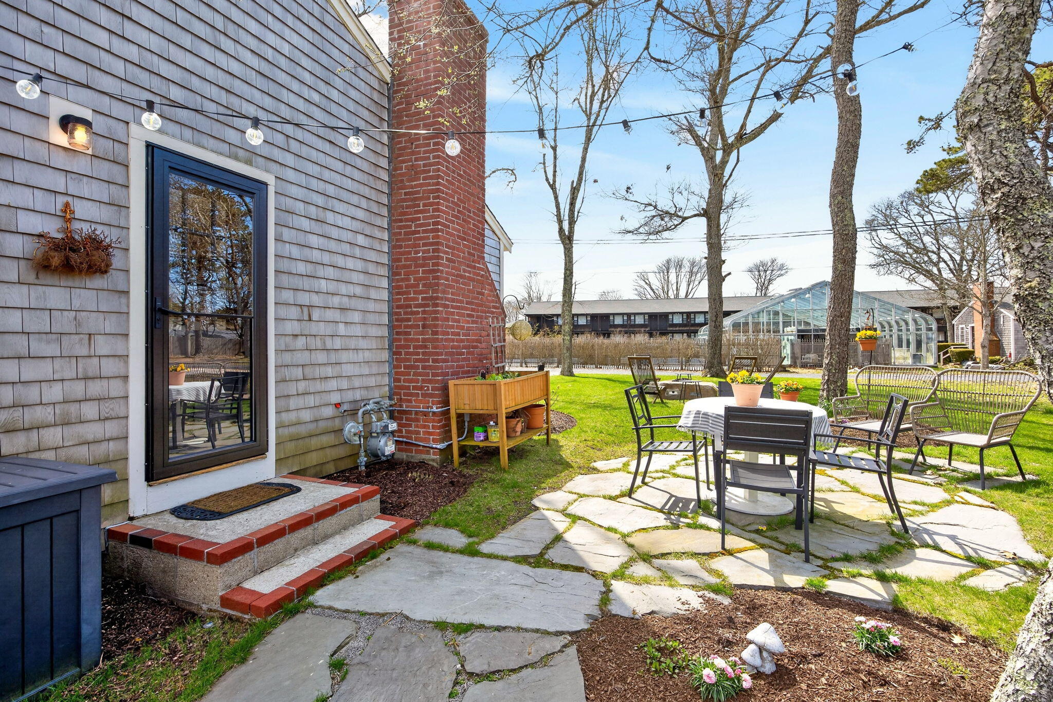 6 Manning Road Dennis Port, MA 02639 - Photo 39 of 53 a roof deck with table and chairs and potted plants