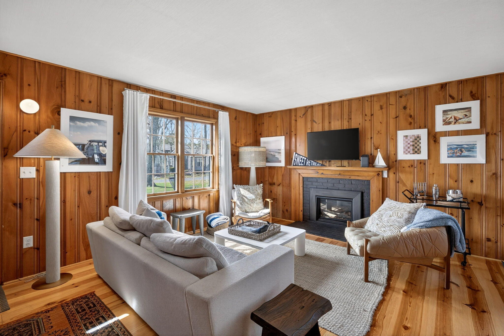 6 Manning Road Dennis Port, MA 02639 - Photo 9 of 53 a living room with furniture a fireplace and a flat screen tv