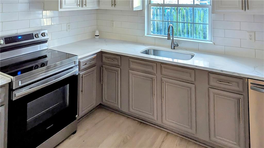 3340 Pinehill Drive Decatur, GA 30032 - Photo 7 of 15 a kitchen with granite countertop a sink stove and cabinets