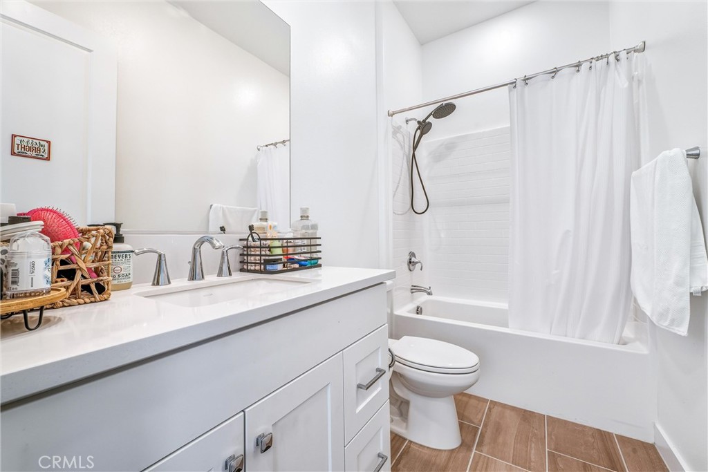 26767 Laurel Mountain Loop Valencia, CA 91381 - Photo 16 of 43 a bathroom with a double vanity sink toilet tub and shower