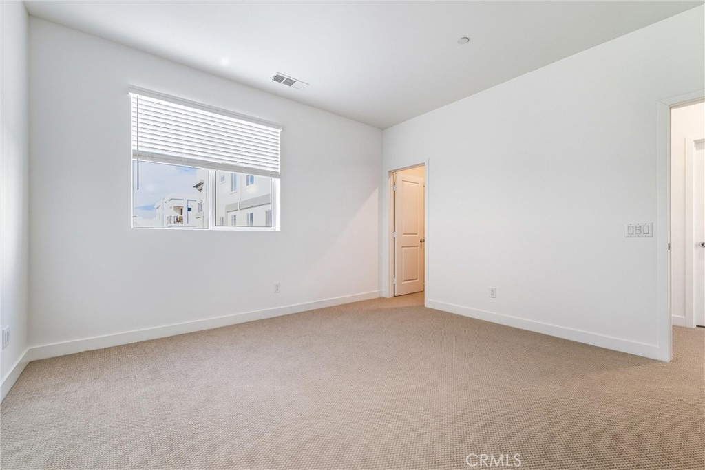 26767 Laurel Mountain Loop Valencia, CA 91381 - Photo 20 of 43 an empty room with a window