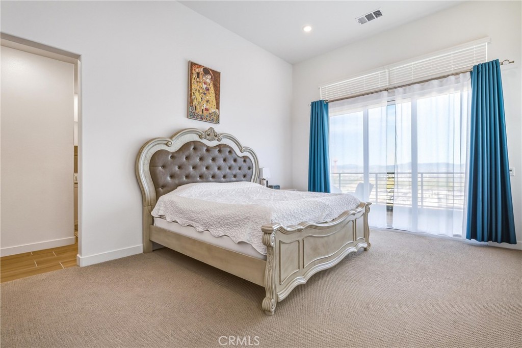 26767 Laurel Mountain Loop Valencia, CA 91381 - Photo 27 of 43 a bed sitting in a spacious bedroom next to a window