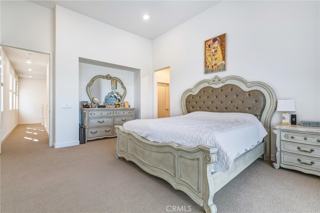 26767 Laurel Mountain Loop Valencia, CA 91381 - Photo 28 of 43 a spacious bedroom with a bed and a dresser