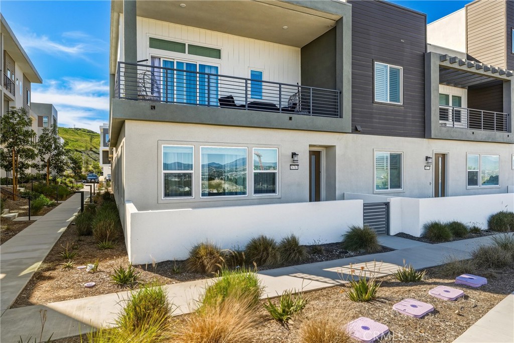 26767 Laurel Mountain Loop Valencia, CA 91381 - Photo 3 of 43 a front view of a house with a yard