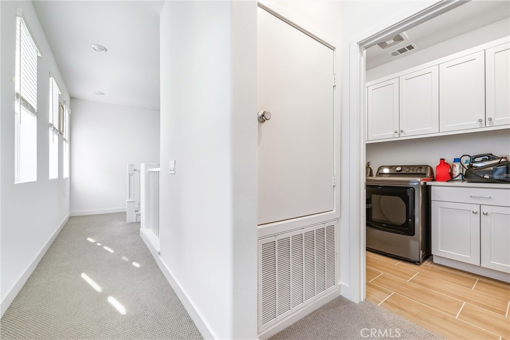 26767 Laurel Mountain Loop Valencia, CA 91381 - Photo 32 of 43 a kitchen with white cabinets and white appliances