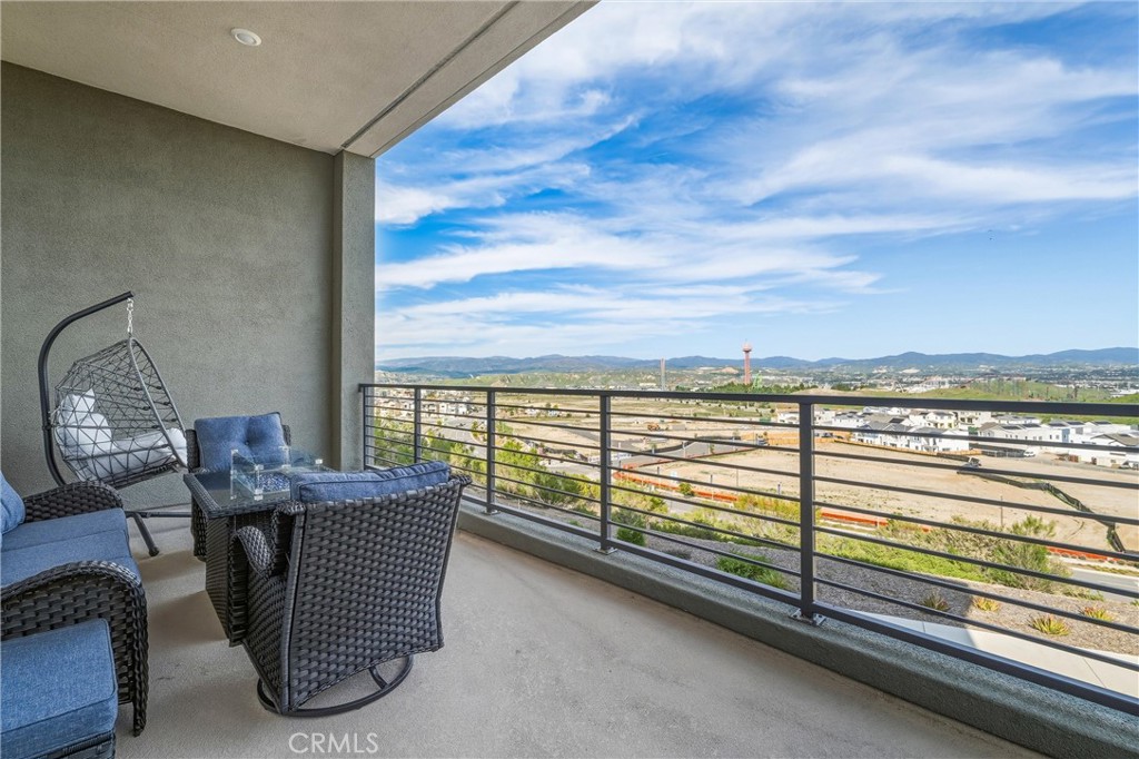 26767 Laurel Mountain Loop Valencia, CA 91381 - Photo 34 of 43 a dining room with furniture and a floor to ceiling window