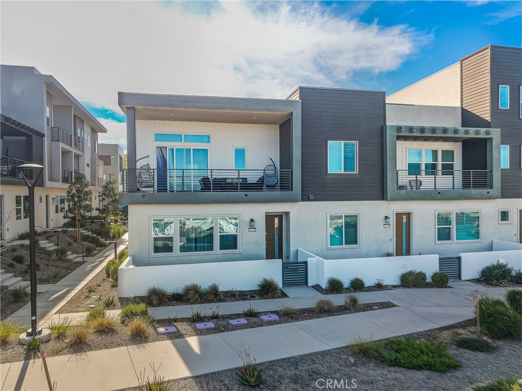 26767 Laurel Mountain Loop Valencia, CA 91381 - Photo 39 of 43 a front view of a house with a yard