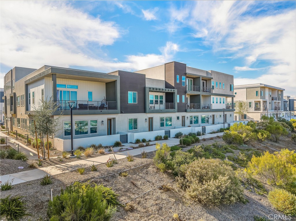 26767 Laurel Mountain Loop Valencia, CA 91381 - Photo 40 of 43 a front view of residential houses with yard