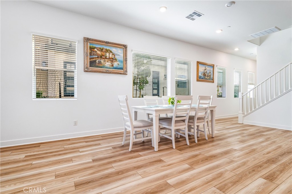 26767 Laurel Mountain Loop Valencia, CA 91381 - Photo 6 of 43 a view of a dining room with furniture window and wooden floor