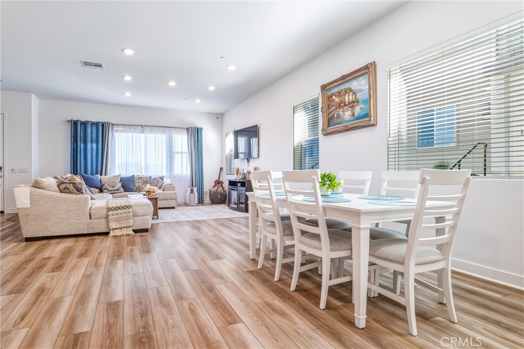 26767 Laurel Mountain Loop Valencia, CA 91381 - Photo 7 of 43 a view of a dining room with furniture window and wooden floor
