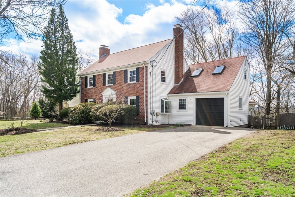 43 Palmer Road Newton, MA 02468 - Photo 37 of 40 a front view of a house with a yard and garage