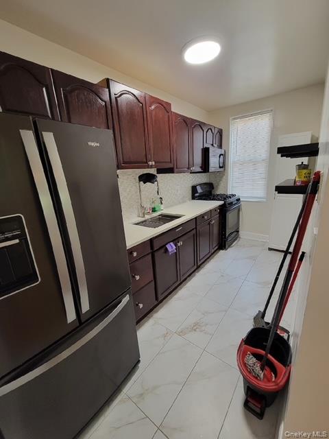 780 Bronx River Road, Unit A52 Yonkers, NY 10708 - Photo 2 of 6 a kitchen with stainless steel appliances granite countertop a sink and cabinets