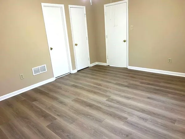 a view of a room with wooden floor