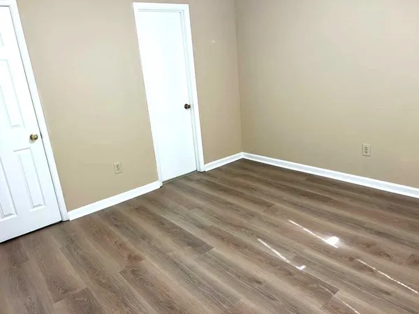 an empty room with wooden floor