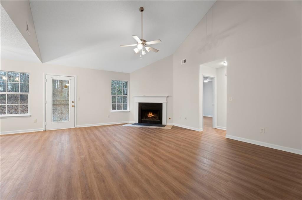 7815 Ridge Top Terrace Douglasville, GA 30134 - Photo 12 of 31 an empty room with wooden floor fan and windows
