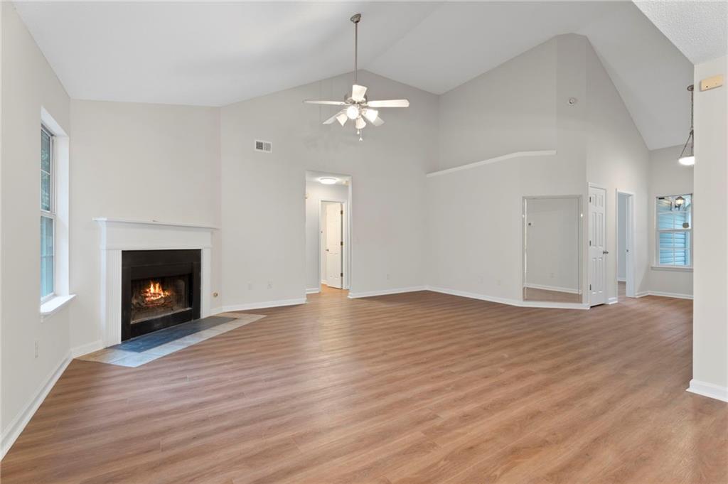 7815 Ridge Top Terrace Douglasville, GA 30134 - Photo 13 of 31 a view of an empty room with wooden floor fireplace and a window