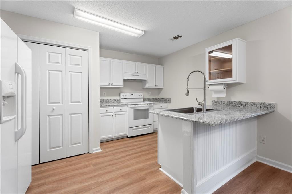 7815 Ridge Top Terrace Douglasville, GA 30134 - Photo 17 of 31 a kitchen with stainless steel appliances granite countertop a sink stove and refrigerator