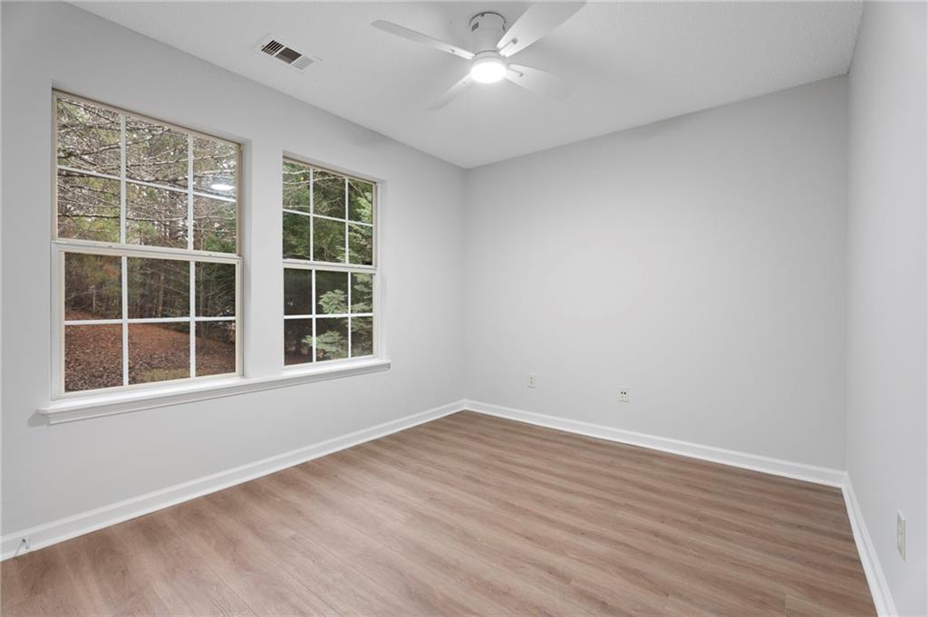 7815 Ridge Top Terrace Douglasville, GA 30134 - Photo 21 of 31 an empty room with wooden floor and windows