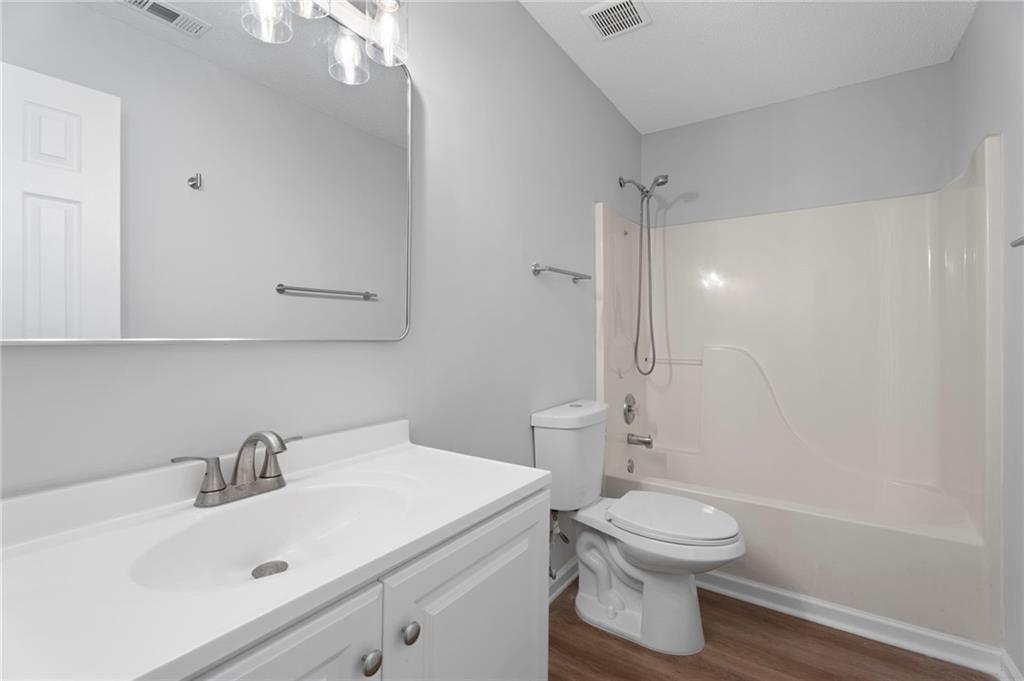 7815 Ridge Top Terrace Douglasville, GA 30134 - Photo 23 of 31 a bathroom with a sink a toilet and shower