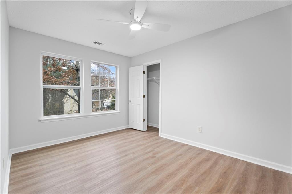 7815 Ridge Top Terrace Douglasville, GA 30134 - Photo 24 of 31 an empty room with wooden floor and windows