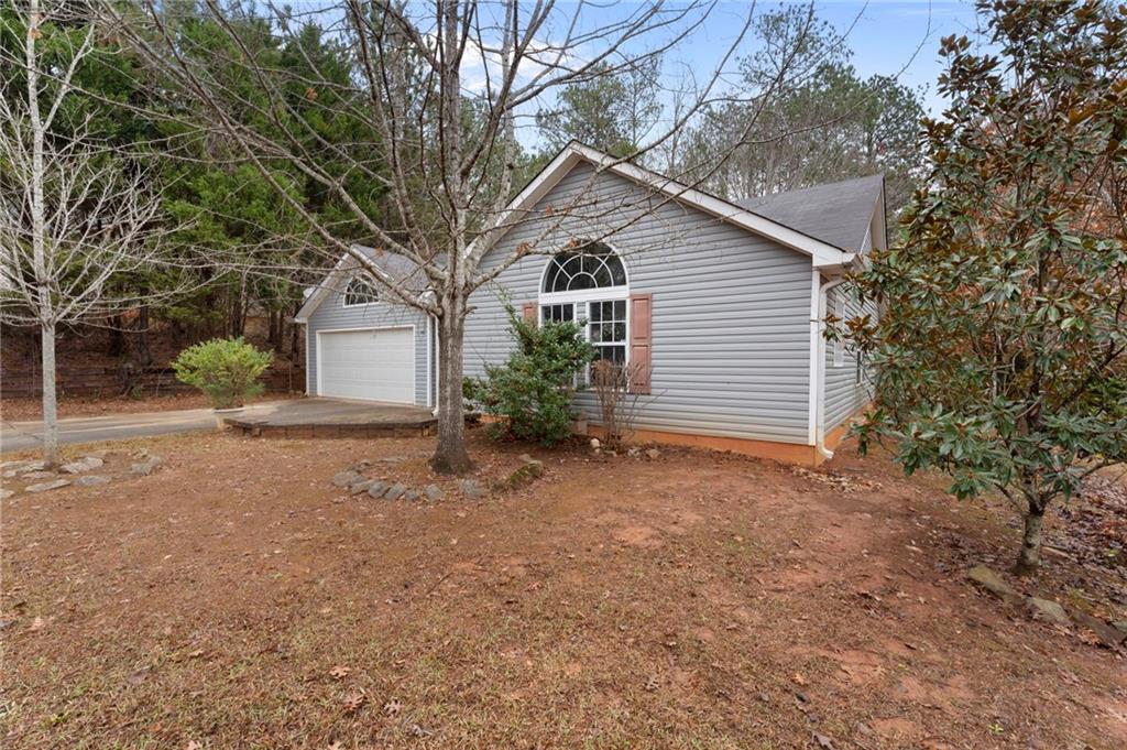 7815 Ridge Top Terrace Douglasville, GA 30134 - Photo 30 of 31 a view of a house with a yard and garage