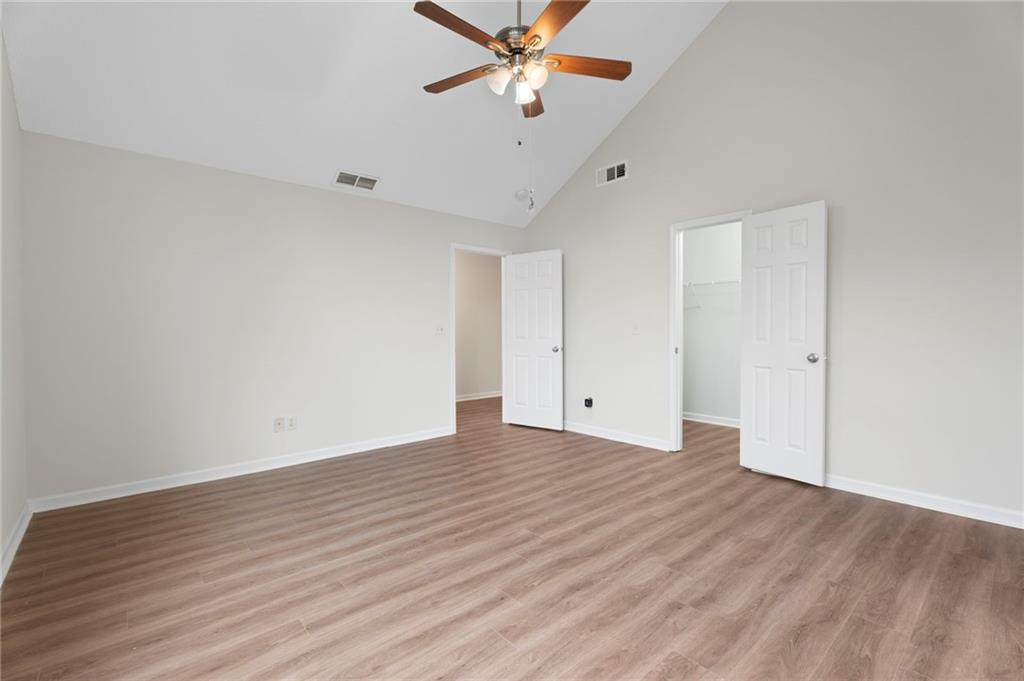 7815 Ridge Top Terrace Douglasville, GA 30134 - Photo 7 of 31 a view of a room with wooden floor and a ceiling fan