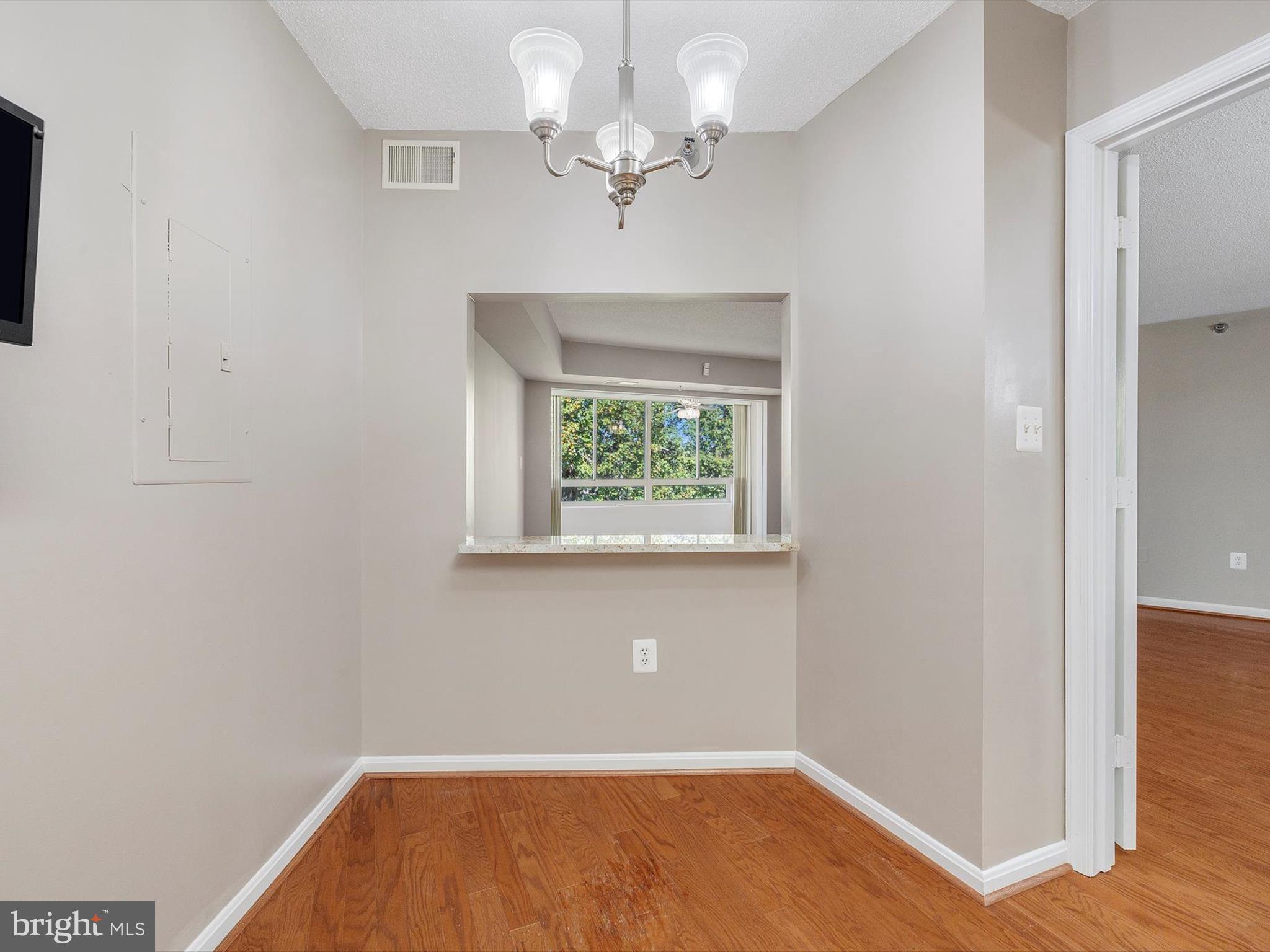 14809 Pennfield Circle, Unit 406 Silver Spring, MD 20906 - Photo 21 of 45 wooden floor in an empty room with a window