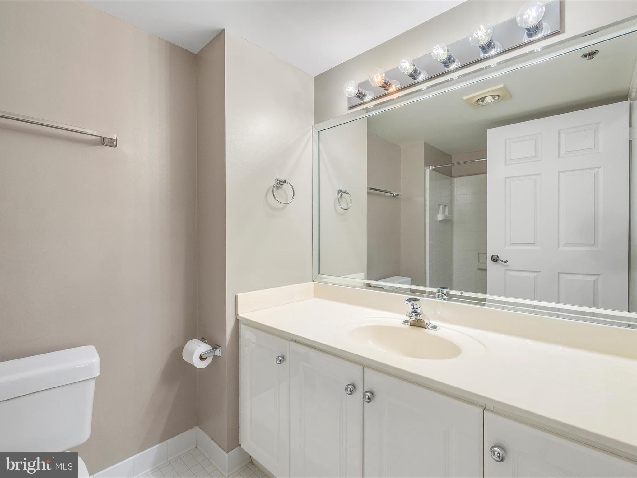 14809 Pennfield Circle, Unit 406 Silver Spring, MD 20906 - Photo 29 of 45 a bathroom with a sink double vanity and a mirror