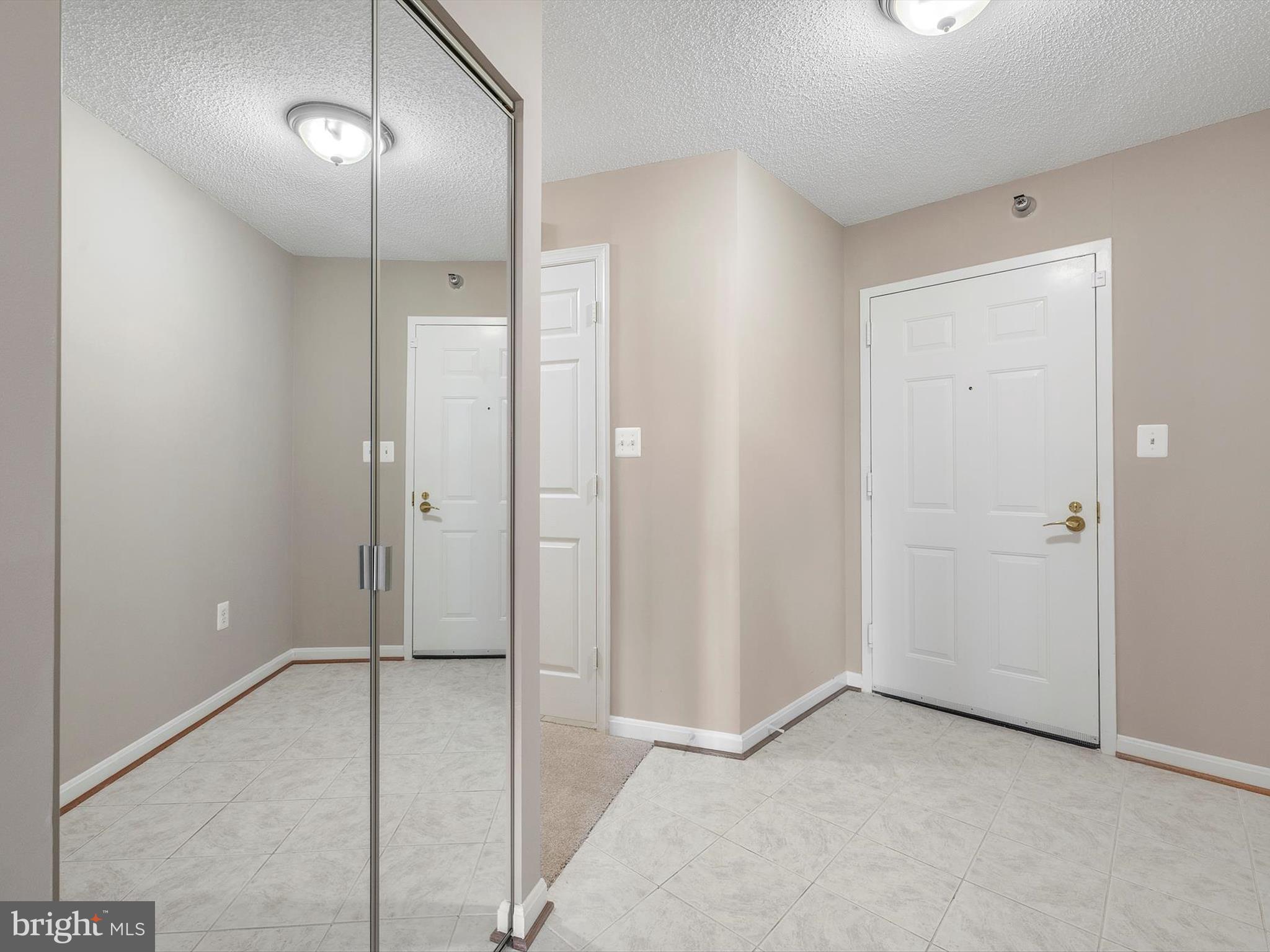 14809 Pennfield Circle, Unit 406 Silver Spring, MD 20906 - Photo 4 of 45 a view of an empty room with a mirror